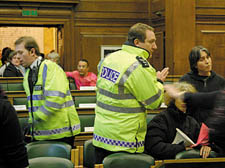 Police clear the council chamber 