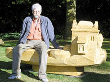Sculptor Friedel Buecking sits on one of his works. 