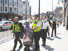 A man is led away by police officers close to Camden Town Tube station after the incident on Tuesday