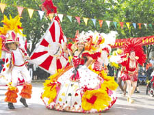 Dancers from the Paraiso School of Samba strut around Chalcot Square.