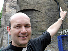 Camden vicar Malcom Hunter outside St Michael's Church, NW1