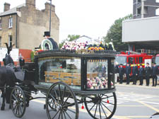 The horse-drawn carriage carrying the body of Miriam Baldock, makes its way past Kentish Town fire station on Friday 