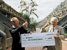 Housing chief Naylor presents a cheque to tenant Nigel Barnes