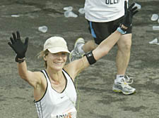 Runner Rebecca Hossack crosses the finish line