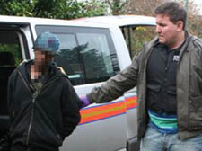 An officer arrests a suspect as part of the anti-drug operation