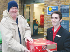 The New Journal's Don Ryan picks up the Christmas hampers from Camden Town Marks and Spencer food manager Lee Collis 