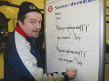 Underground employee Richard Norgrobe shows of some examples of his calligraphy handiwork
