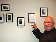 Peter Deed points to the empty frame where he hopes a picture of Father Page might soon appear