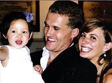 Gavin and Teresa Allen with their adopted baby, Bo, at her christening in Hampstead