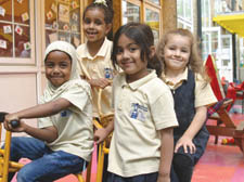 Sadia Sharif and Naomi Bereket, both five, Aneeka Subhan, four, and Amelia Tusha, five, celebrate the opening of the Brecknock School �children's centre by newsreader Jon Snow