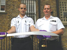 PC Jonathan Oram and Police Sergeant Neil Payn of Camden Town Tasking Unit, with a samurai sword sold to a 15-year-old for 49