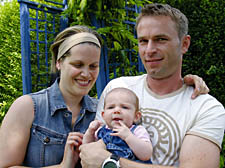 Adrienn Both and Andras Toth with their baby Csenge in their garden in July