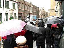 Shoppers brave the rain queueing in Mandela Street at the French Connection sale on Friday