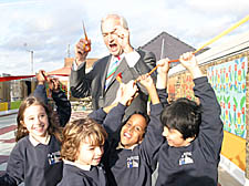 As Snow cuts the tape, he promises pupils: 
