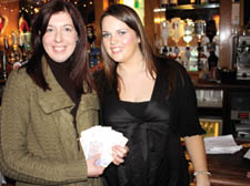 The New Journal's Sarah Starkins (left) hands over her prize winnings to Caroline Maloney