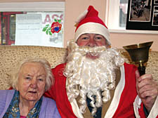 Santa 'Courtney O'Connor' Claus presents a hamper to Bridget Crowley
