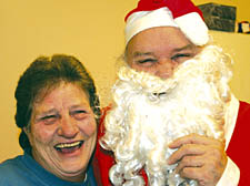 The New Journal’s stand-in Santa, Jack Courtney O’Connor, meets Eva Williams as he delivers a hamper to the Camden Town pensioner