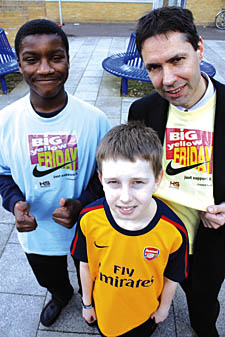 Reece Bullock, centre, with fundraiser Nii Ribeiro and teacher Simon Balestrini at Haverstock School&rsquo;s Big Yellow Friday