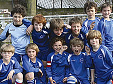 We’re on our way: Belsize Park U-9s celebrate their showdown final date with Hampstead U-9s whose skipper Callum Smith (right) has the backing of No 1 fan, granddad Brian