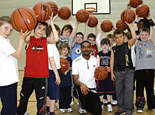 Coach Zac Roswell with youngsters at his Talacre basketball class