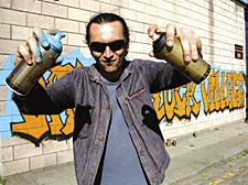 Artist Ivan Mott and a graffiti piece he created at the Canal Market