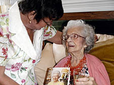 Constance Green celebrates her 100th with niece Sheila Newman-Coburn and her birthday card from the Queen