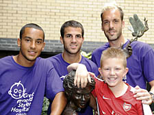 Arsenal players Theo Walcott, Cesc Fabregas and Manuel Alumunia with Jake, 12, at GOSH