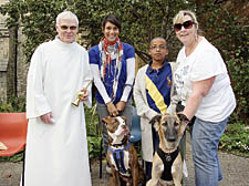 Father Tom Forde with Pushkin Cambridge and Cory Bailey, 9, with Archie and Sonya Humphries with Jethro