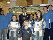 Youngsters from Hampstead Football Club at the Town Hall present mayor Faruque Ansari with the official bid for new pitches at Chase Lodge, along with representatives from Kentish Town FC