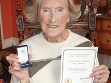 Hilary Bedford with the medal she recently received from Gordon Brown