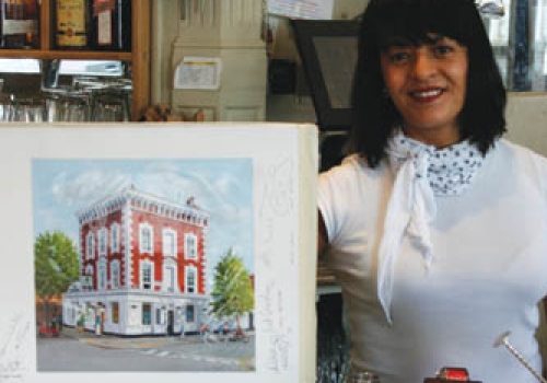 Waitress Karla Camacho-Willey with the signed painting of the Engineer 