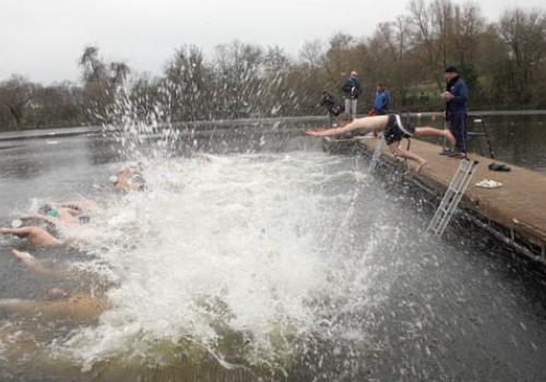 Highgate Pond all-comer swimmers brave the Christmas Day conditions. 