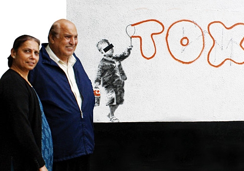 The Banksy piece being sold by Bhupen Raja, pictured with his wife, Hena