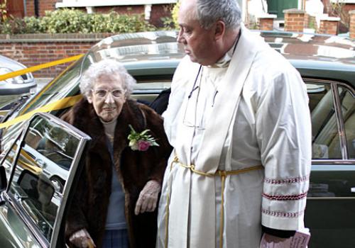 Fr David Houlding escorts Marjorie to the church