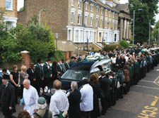 Mourners line the street for Martin Dinnegan’s funeral. Right, family and friends leave the church
