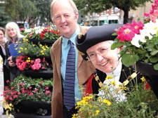 Mayor Barbara Smith with judge Simon Richards and floral display outside the Town Hall 