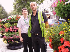 Steve Long tends to his flowers with Andrew Bedford outside Islington town hall