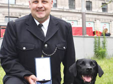 Vinnie, with PC Dave Coleman and his bravery medal 