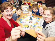 Liliey Burgess is joined by fellow pupils at Thornhill School and Councillor Ursula Woolley to launch her board game