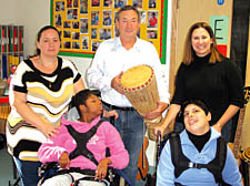 Nick Mason with pupils Chantal Guzman, 13, and Fatima Rehman, 16, and teaching assistants Brenda Murphy and Jennifer Raby