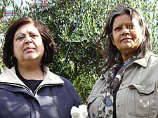 Cllr Theresa Debono and Pam May with polysterene blown into garden