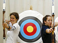 Islington leisure chief Councillor Ruth Polling (left) tries her hand at archery, one of the free activities for the weekend, under the watchful eye of Aisha Zeina, instructor at 2020 Archery, Barnsbury Terrace
