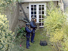 Armed police officers in the back garden of an Upper Holloway house following the gun siege