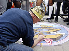 Steve Edgeoeley works on his pavement art in Archway