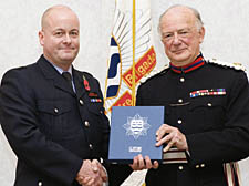 Carl Barlow receives his award from Sir Michael Craig-Cooper