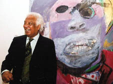   Albert Adams stands in front of one of his paintings entitled ‘Celebration’ 