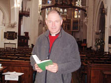 The Rev Robert Atwell with a copy of the English Hymnal 