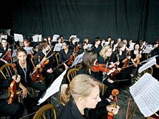 The NYO string section prepare to play the Pyramid Stage in Glastonbury in June
