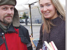 Jon Privett at his Archway market stall with customer Claire Hall
