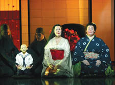 Judith Howarth (Cio-Cio-San) waits with her son, the puppet Sorrow, and maid Suzuki (Karen Cargill) for Pinkerton (Gwyn Hughes Jones), below left
